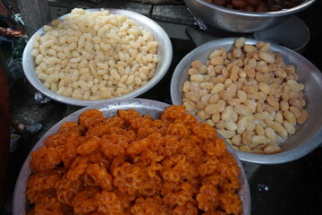 Freshly made sweet Jalebi or Imrati are served for sale in a sweet shop, Closeup shot of hot Jalebi dipped in syrup are ready for sale, Fried sweet Jalebi are on display to attract customer