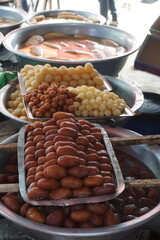 Popular Bangladeshi dessert Gulab Jamun with sugar syrup, Traditional Bangladeshi sweet called rasgulla or rasgoola is being sold at a market, Gulab jamun and rasgulla are displayed together