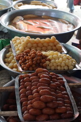 Popular Bangladeshi dessert Gulab Jamun with sugar syrup, Traditional Bangladeshi sweet called rasgulla or rasgoola is being sold at a market, Gulab jamun and rasgulla are displayed together