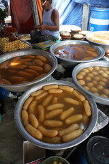 Popular Bangladeshi dessert Gulab Jamun with sugar syrup, Traditional Bangladeshi sweet called rasgulla or rasgoola is being sold at a market, Gulab jamun and rasgulla are displayed together