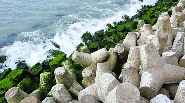 Coast wave breaker stones at Porbandar seaside, Porbandar, Gujarat, India.