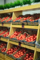 Fresh Tomatoes in a Box on a Market Shelf