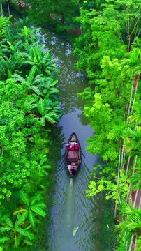 A beautiful Lake  on floating boat  in the middle of a deep forest, as seen in this cinematic vertical aerial Video