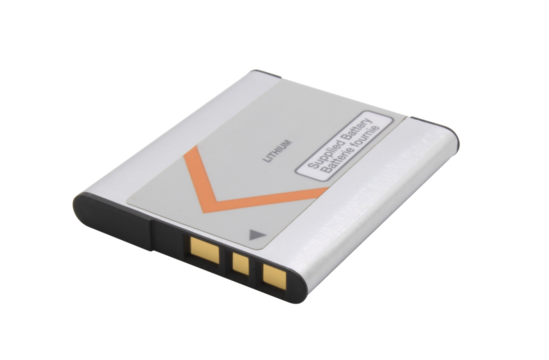 Old lithium battery from a camera with gold contacts on an isolated background.