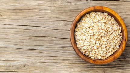 Oats in wooden bowl on rustic wooden table, natural and healthy food product.