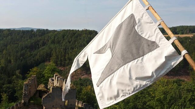 View from the tower of the medieval castle with a flying replica of the historical banner, Czechia