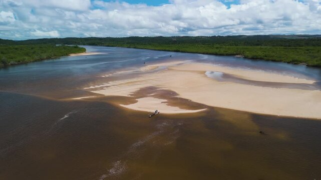 Aerial view orbiting a traditonal fishing boat landed on a sandbank in Brazil