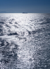 A ship on the horizon in the Aegean Sea in Greece