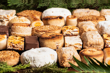 Typical Christmas sweets displayed in rows and in extreme close-up, taking up the entire image.