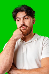 A man with a serious expression stands against a vibrant green background