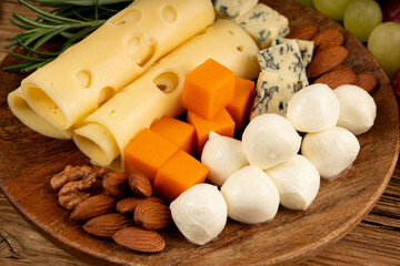 Cheese plate of color cheeses variety, yellow, white and blue cheese board, assorted dairy products