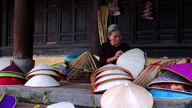 old woman making conical hats - Vietnamese name is Non la. Lang Chuong village, Hanoi city, Vietnam