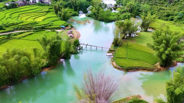 Aerial landscape in Quay Son river, Trung Khanh, Cao Bang, Vietnam with nature, green rice fields and rustic indigenous houses