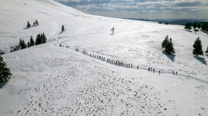 Snow hike with lots of people on a mountain, Romania, Lacul Vulturilor, Mălâia