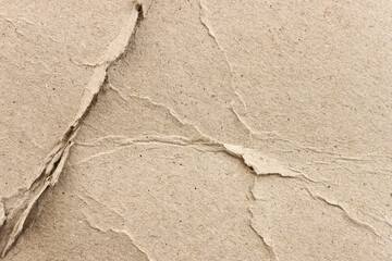 cardboard sheet textured background with crumples and torn, brown color