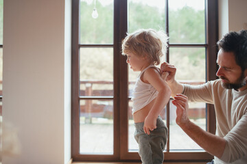 Father is checking his son's skin, looking for rashes or skin reactions.