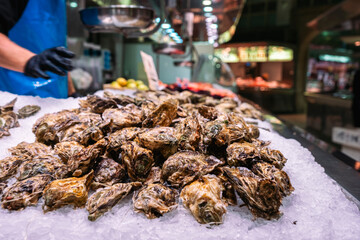 Fresh oysters and shellfish in ice on stall at Valencia Fish Market