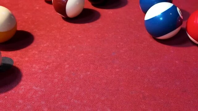 Colorful billiard balls on a red pool table for leisure or sports-themed events