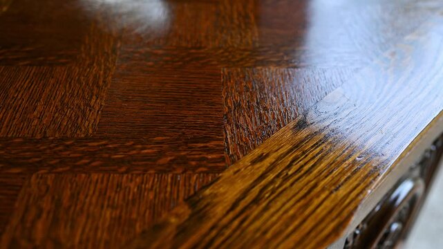 This is a closeup image of a beautifully polished wooden table that showcases its intricate and artistic patterns