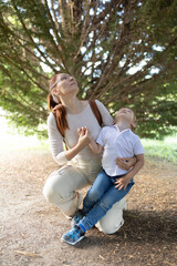 Fototapeta premium A woman and a child are sitting in a park