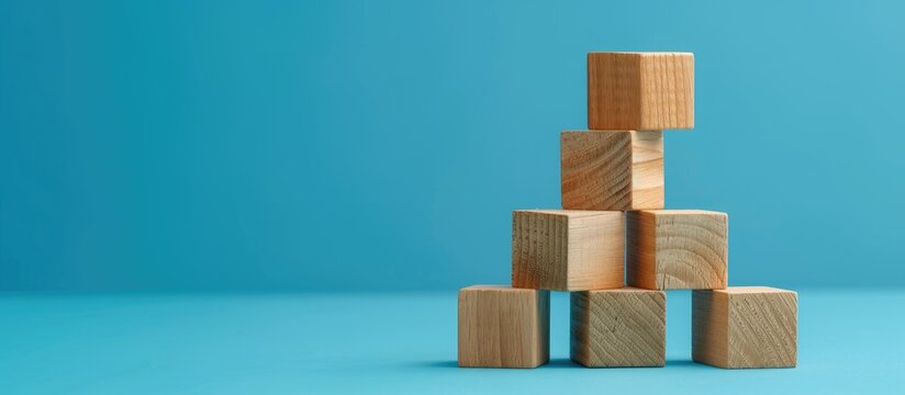 Wooden blocks conveying a rental income message against a blue background creating a symbolic representation with available copy space image