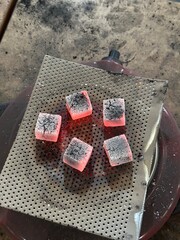 Fire burning from coconut charcoal briquette for business production