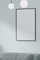 A empty black picture frame mockup hangs above a modern sofa, perfect for displaying your art.
