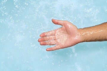 Fototapeta premium Close up of a Swollen Red Hand Under Cold Running Water After a Burn Injury