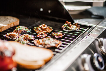 Grilled mushrooms and bread on a barbecue grill