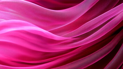 Obraz premium A tight shot of pink fabric showcases a long, flowing segment against a backdrop of black