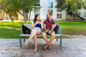 Quiet study partners in university campus with notebooks and headphones on