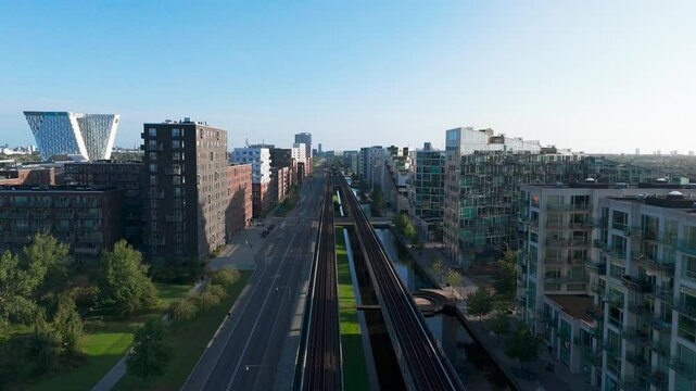 Aerial - empty street and main Orestad metro line, residential area, Copenhagen