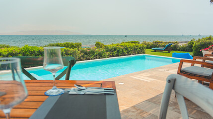 A table with a glass of wine and a spoon on it