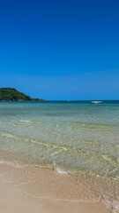 Idyllic tropical beach with clear blue water and pristine sand, perfect for summer escapes and relaxation tourism on a sunny day