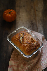 High angle photo of a freshly baked beautiful loaf of sourdough bread in on a kitchen counter