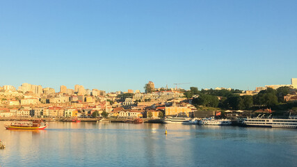 Fototapeta premium A picturesque view of Porto's Ribeira district with boats on the Douro River, ideal for a holiday getaway