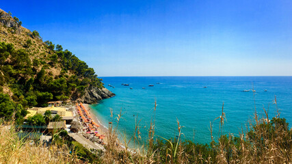 A stunning coastal view of a secluded Mediterranean beach, perfect for summer vacations and...