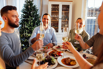 A happy big family at the dining table in the dining room at home