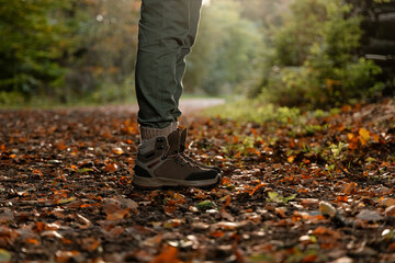 Close-up of female feet in hiking sneakers walking along a forest path, copy space for text stock photo.