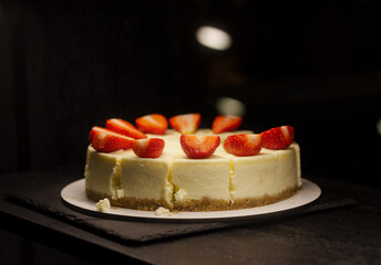 Cheesecake cut with a knife. with fresh fruits, strawberries.