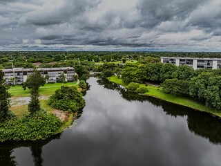 Aerial view of a suburban landscape with lush greenery under a cloudy sky. Lauderhill, Florida