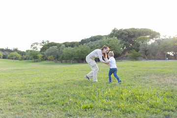 Mother and son playing in the park on sunny summer day