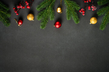 Christmas flat lay background with fir tree and holiday decorations on black.