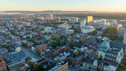 Aerial view of downtown Harrisburg, Pennsylvania, at sunrise, showcasing the city&rsquo;s historic buildings and streets.