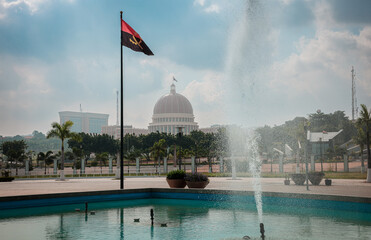 Fountain with the Angolan flag waving near the presidential palace in Luanda during a clear day