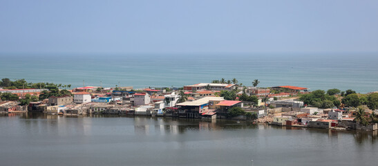 Fototapeta premium Coastal view of Luanda Angola showcasing waterfront homes along the shoreline under a clear blue sky