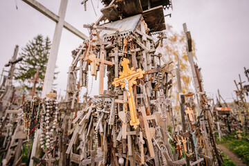 A large collection of wooden crosses, crucifixes, and rosaries displayed at Kryžių Kalnas (Hill...