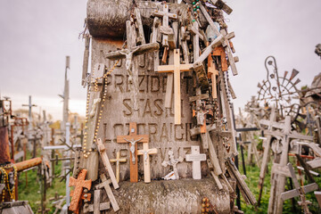 A large collection of wooden crosses, crucifixes, and rosaries displayed at Kryžių Kalnas (Hill...