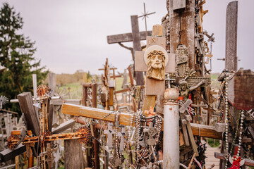 A large collection of wooden crosses, crucifixes, and rosaries displayed at Kryžių Kalnas (Hill...