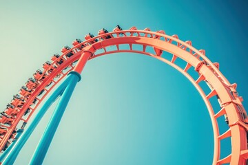 Obraz premium Thrill-seekers experience the rush of a rollercoaster as it climbs to incredible heights against a vibrant blue sky. The amusement park buzzes with excitement and anticipation from onlookers.